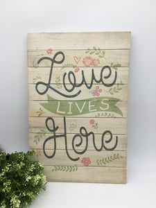 Love lives here ... Wood Wall Decor 18” x 12”